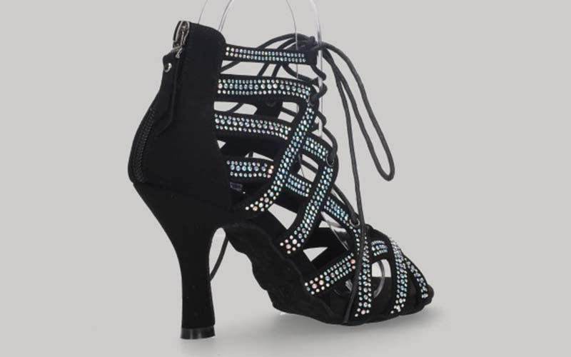 Black ankle boot for ballroom dancing with criss-cross crystal rhinestone straps, laces, and a zipper closure on the heel