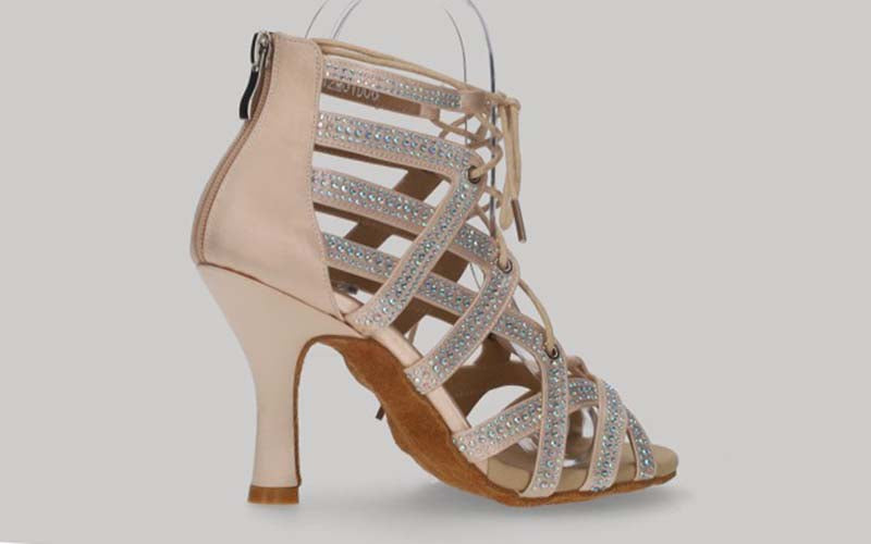 Pink ballroom ankle boot with crystal rhinestone cross-over straps, laces, and zipper closure at the heel