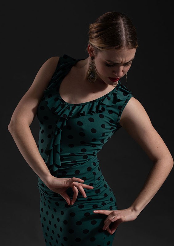 Green printed short strap top with neckline and ruffles.