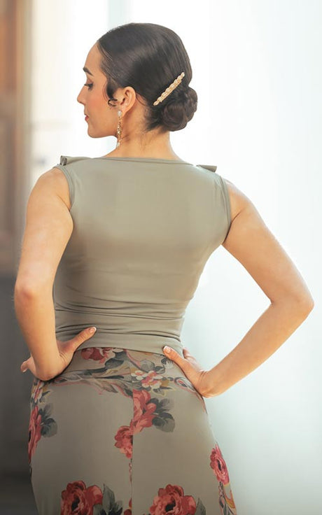 Short strappy top with neckline and ruffles in various colors.