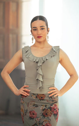 Short strappy top with neckline and ruffles in various colors.